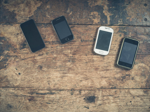 Selection Of Smart Phones On Wooden Table