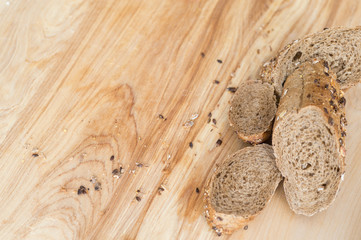 baguette rye bread sprinkled with various seeds on a wooden board