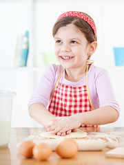 Little girl making the dough