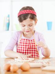 Little girl making the dough