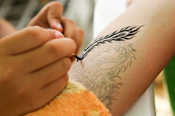Closeup Tattoo artist at work