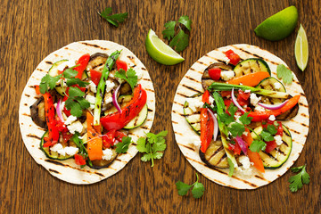 Vegetarian snack tacos with grilled vegetables and salsa.