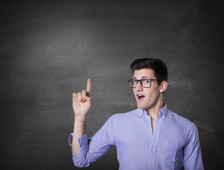 Happy smiling young man presenting and showing your text 