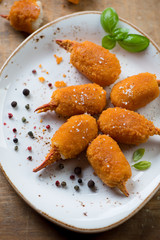 Close-up of breaded crab claws with basil and various spices