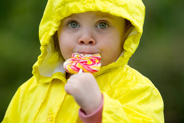 cute little girl eating a lollipop