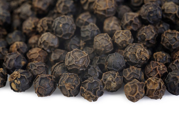 Black pepper seeds on white