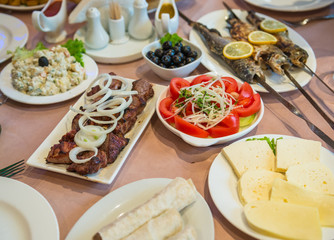 roasted fishes and lamb shish kebab called  mtsvadi - traditional food in Georgia