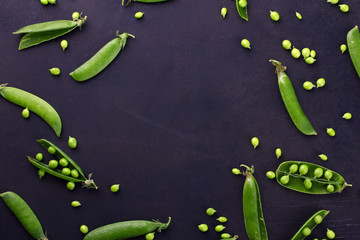 Fresh green peas on a black background