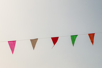 Multi Colored Triangular Flags Hanging in the Sky