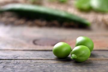 Fresh green peas on a wooden background. Peas on sacking