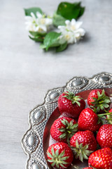 Obraz na płótnie Canvas Fresh strawberries in vintage silver plate