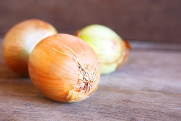 Many Onions on Wooden as Background.