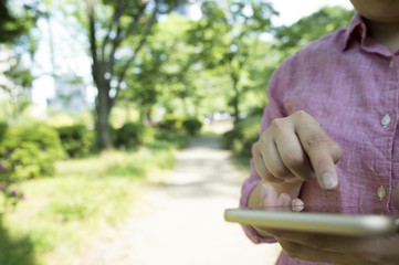 Women have a mobile game in the park