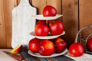 Tasty ripe apples on serving tray on wooden background