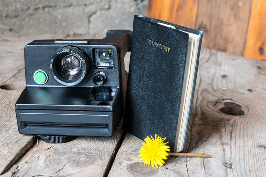 Travel concept-vintage old Polaroid Camera with passport