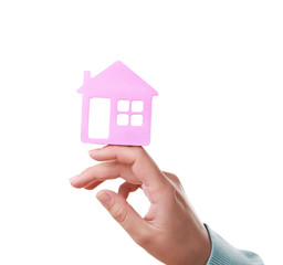 Female hand with small model of house isolated on white