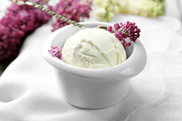 Beautiful composition with tasty ice cream and lilac flowers