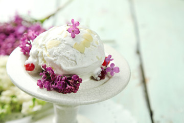Beautiful composition with tasty ice cream and lilac flowers