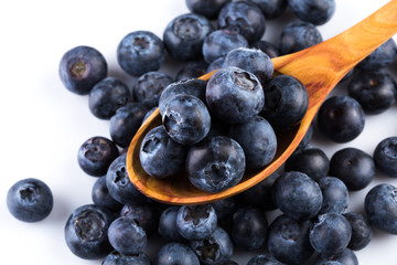 Fresh blueberries in wooden spoon