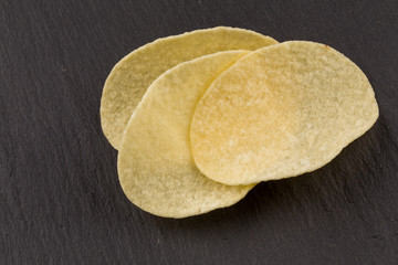 Potato chips on a black background