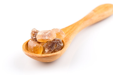 brown caramelized sugar in a wooden spoon