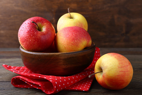 ripe apples in wooden bowl