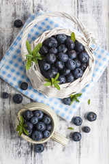 Blueberry basket and jug on white wooden table