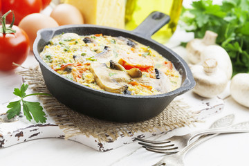 Omelet with mushrooms and tomatoes. Frittata