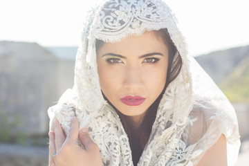 Portrait of a beautiful bride hidden veil