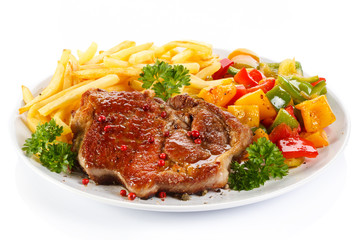 Grilled steak, French fries and vegetables 