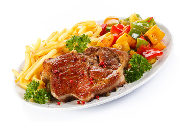 Grilled steak, French fries and vegetables 
