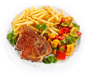 Grilled steak, French fries and vegetables 