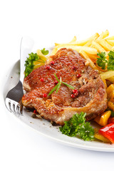 Grilled steak, French fries and vegetables 