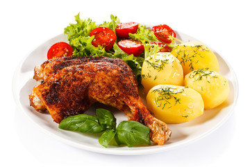 Barbecued chicken leg with boiled potatoes and vegetables