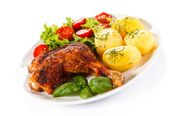 Barbecued chicken leg with boiled potatoes and vegetables
