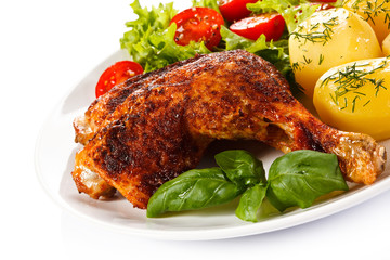 Barbecued chicken leg with boiled potatoes and vegetables