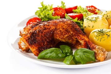 Barbecued chicken leg with boiled potatoes and vegetables