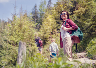 Active family walk in mountain forest