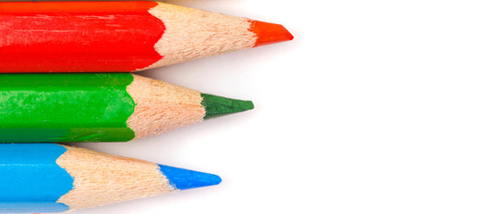 a lot of colorful pencils lying diagonally across a white paper