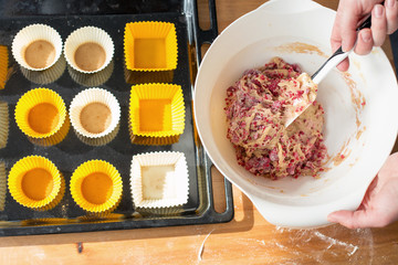 Making muffins with raspberries