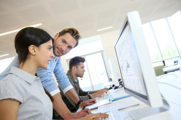 Business people working in office on desktop computer
