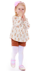 Little girl covers her mouth with his palm