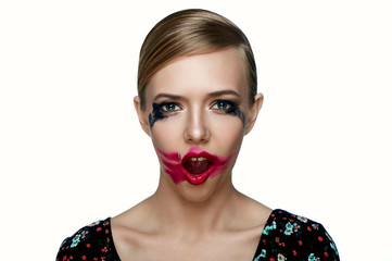 Beauty female Model with smeared red Lipstick on open Mouth.