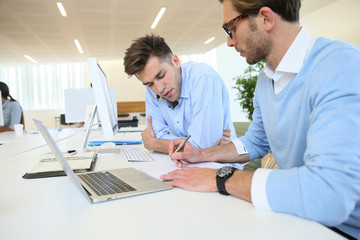 Businessmen in work meeting with laptop computer