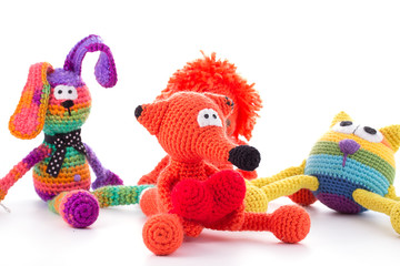 Three knitted toys isolated on white. This image may depict friendship.