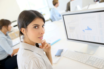 Portrait of young brunette woman working in office