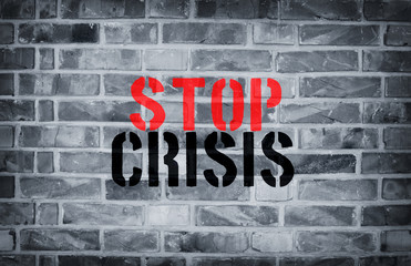 Stop Crisis stencil print on the grunge white brick wall