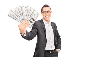 Young successful businessman holding a stack of money