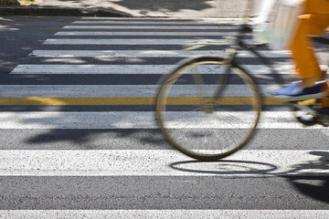Bicycle riders on pedestrian crossing in motion blur