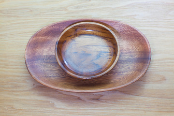 Empty wood bowl on wooden table background